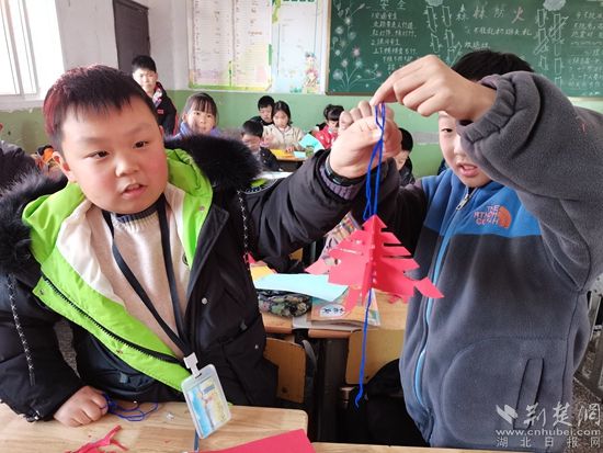 孩子們在展示自己的剪紙作品。.jpg.jpg